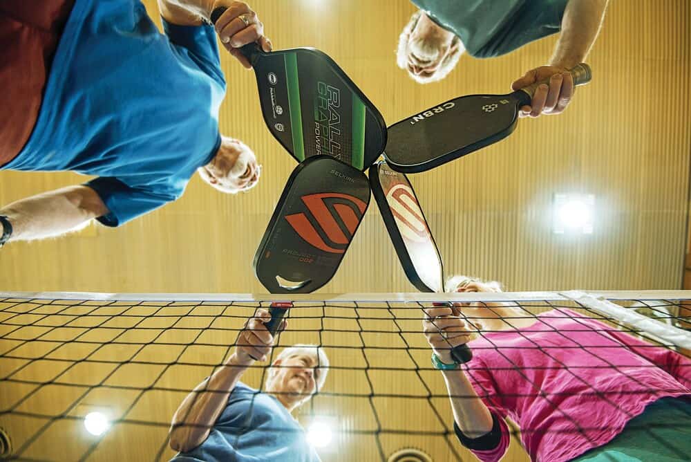 Tapping paddles at the end of the game. Keeping it fun, while maintaining a healthy sense of competitive play in pickleball.